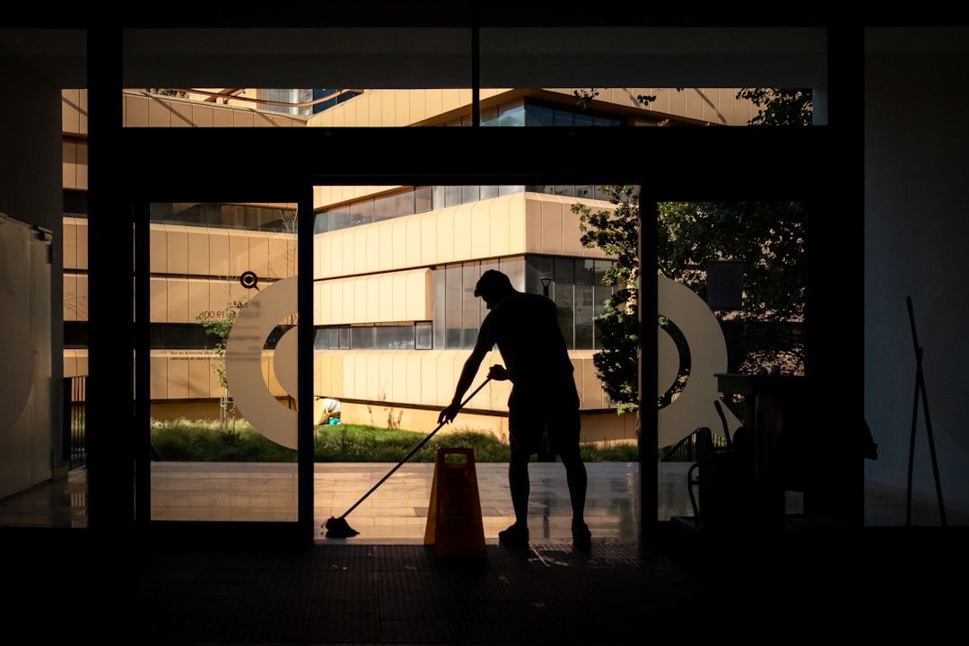 gallery-03 Man cleans floor at an entrance door.